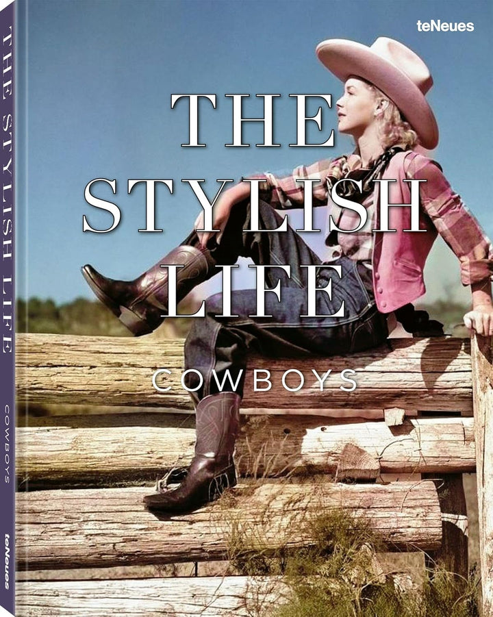 Book cover of 'The Stylish Life: Cowboys' featuring a person in cowboy attire on logs with a scenic background.