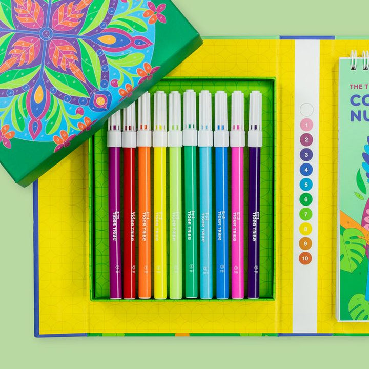 Set of colorful markers with a colorful box on a green background
