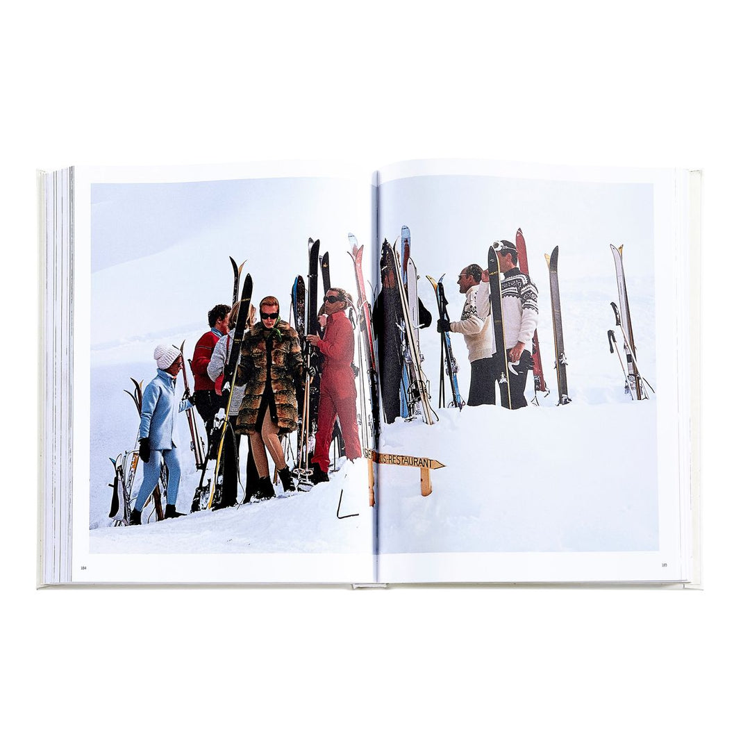 Open book showing a snowy scene with people and skis