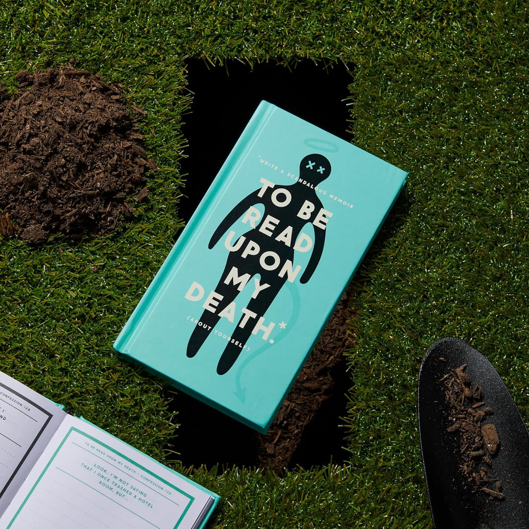 Book titled 'To Be Read Upon My Death' on grass with a shovel nearby
