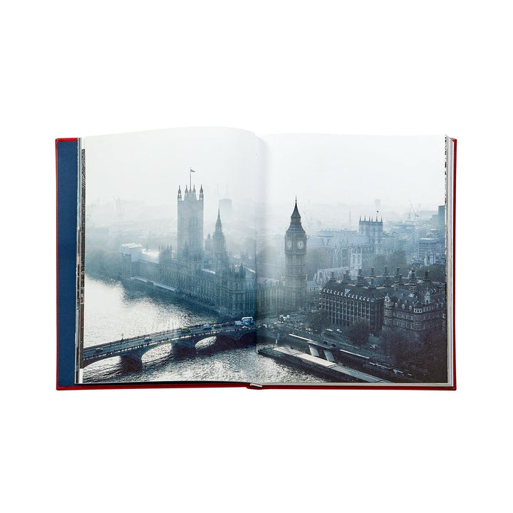 Open book showing a cityscape with a bridge and buildings.