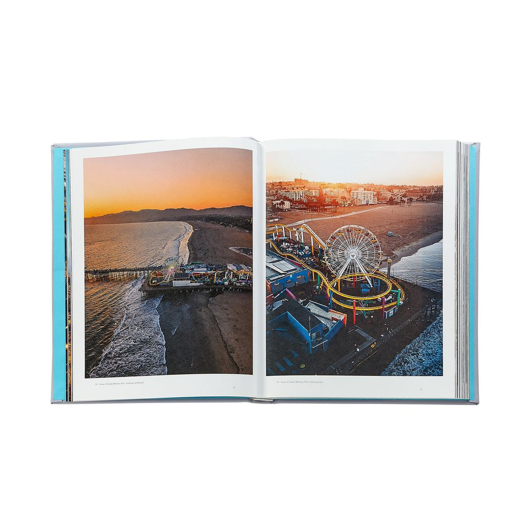 Open book showing a scenic view of a beach and Ferris wheel at sunset.