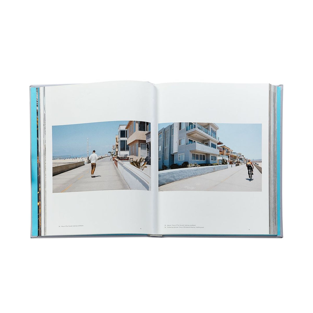 Open book showing two photographs of a coastal street scene with people walking.