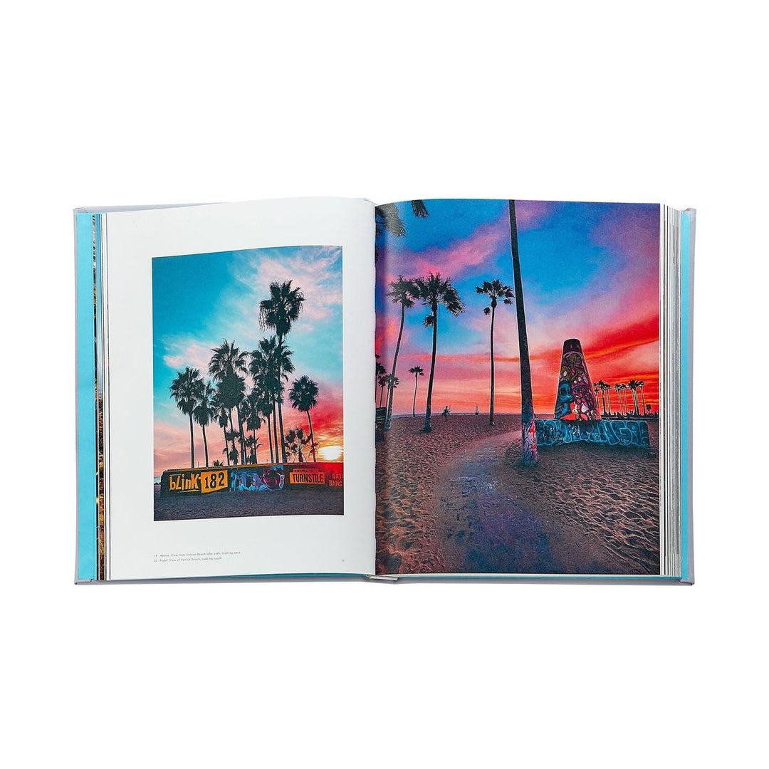Open book showing a colorful beach scene with palm trees and a sunset.