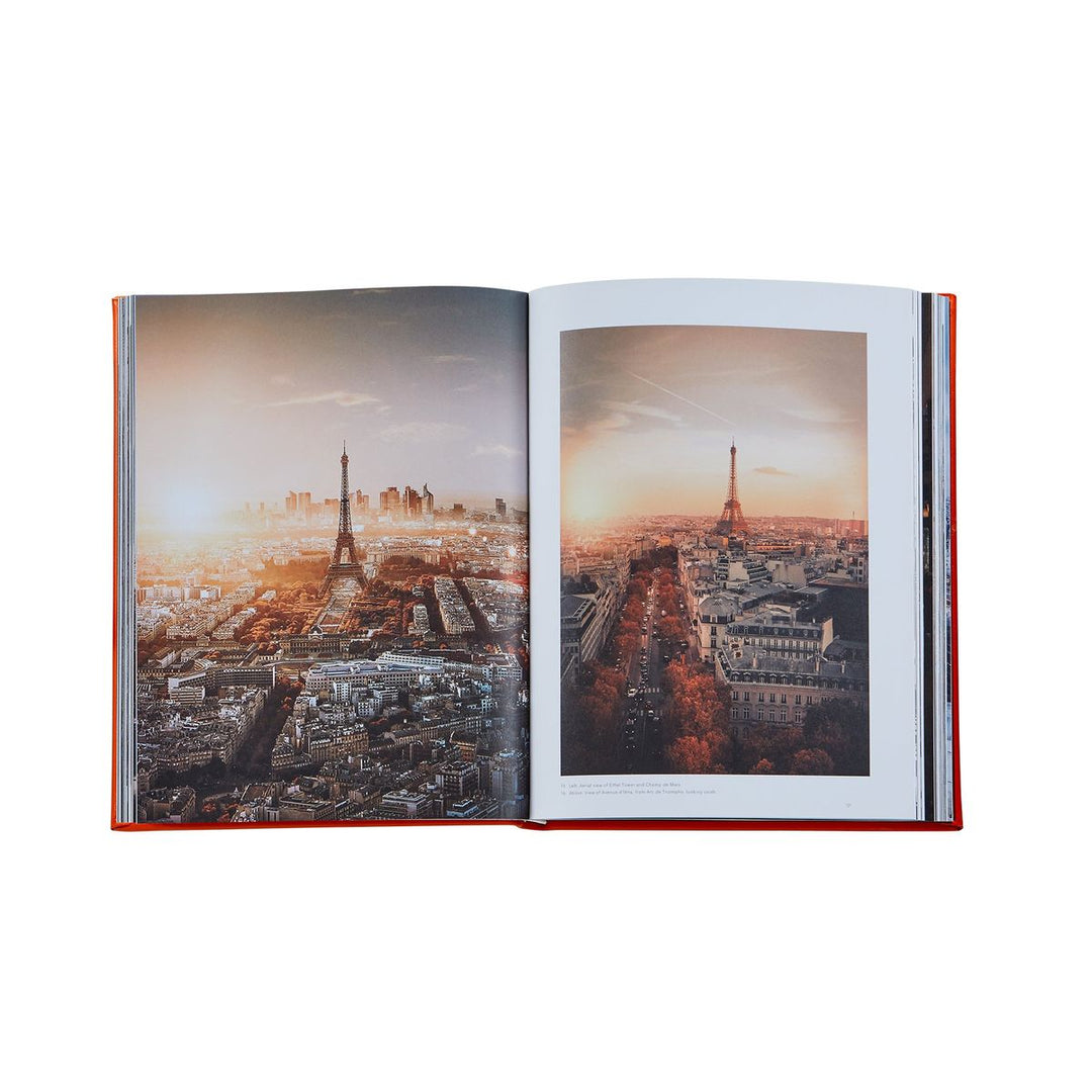 Open book showing two images of a cityscape with a prominent tower.