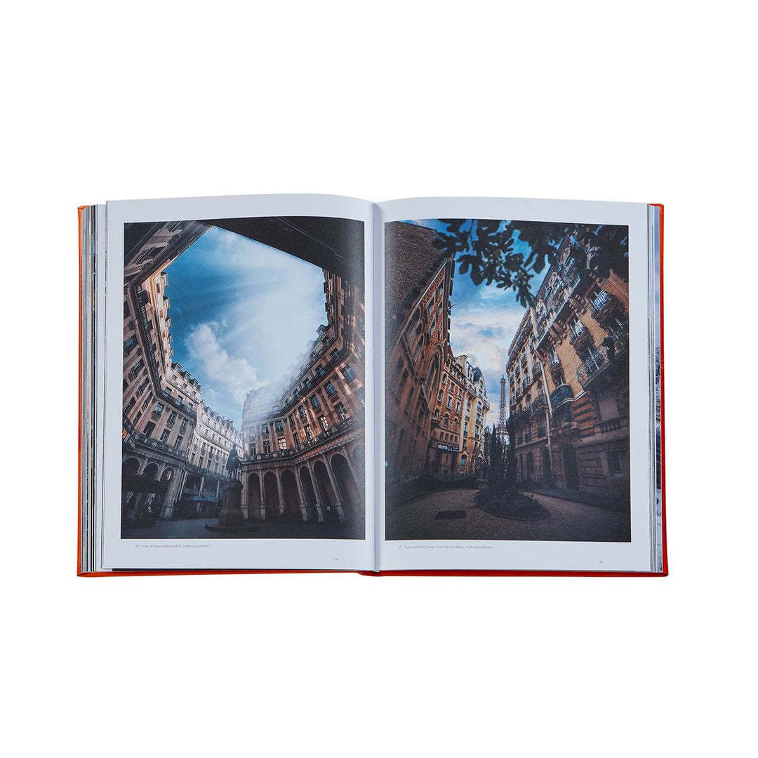 Open book showing a cityscape with buildings and sky.