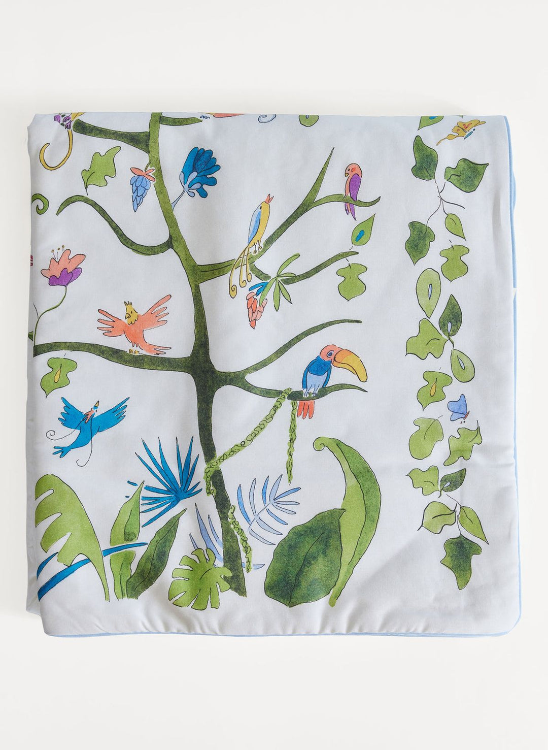 Decorative blanket with a colorful tree and birds design on a white background