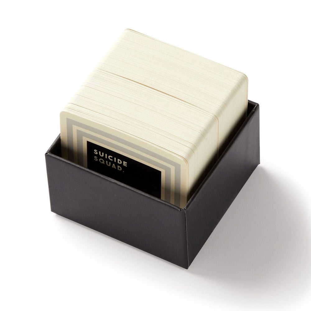 Stack of cards in a black box with 'Suicide Squad' branding on a white background