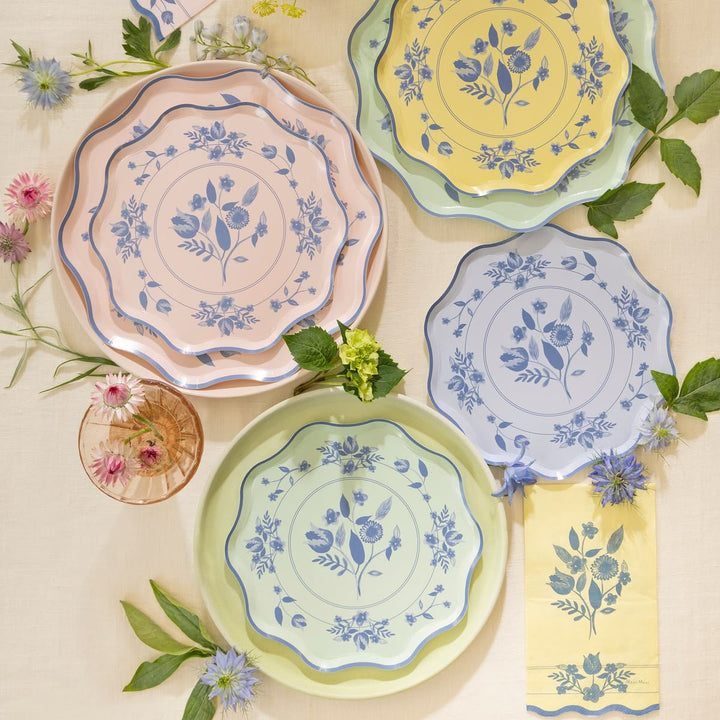 Set of colorful ceramic plates with floral patterns on a light background.