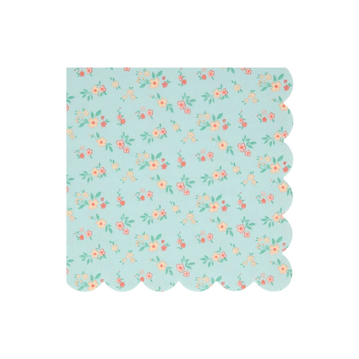A square paper napkin with a scalloped edge, featuring a light blue-green background with a delicate repeating floral pattern in pink, orange, and green.