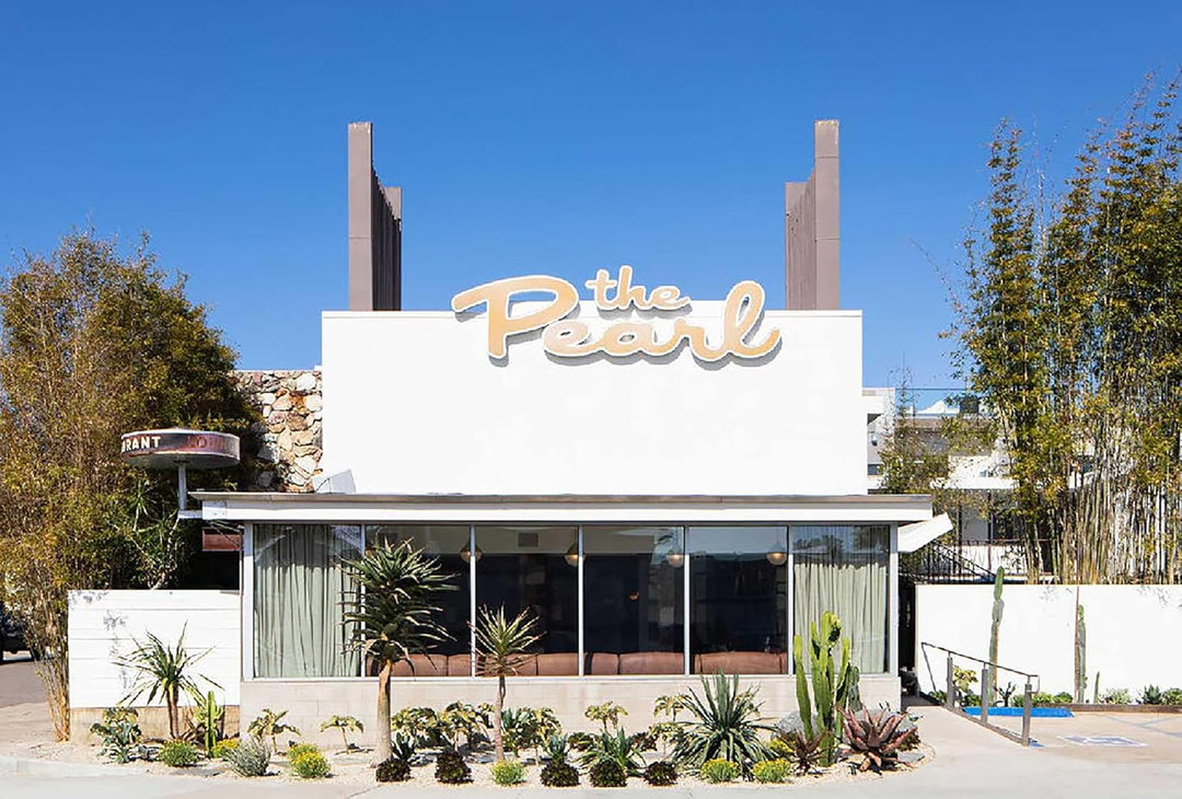 Building with 'The Pearl' sign against a clear blue sky