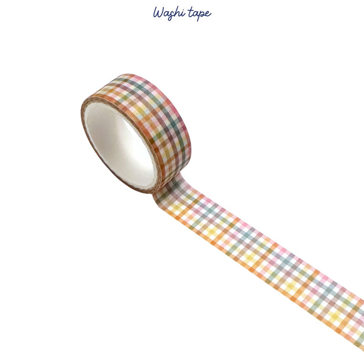 Roll of washi tape with a checkered pattern on a white background