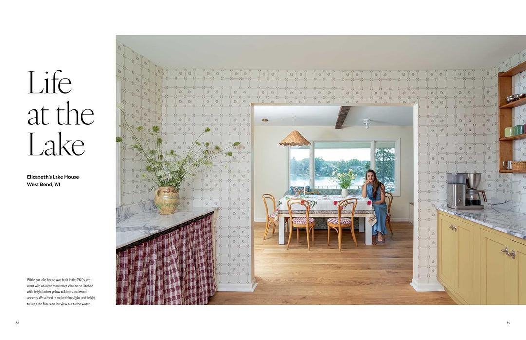 A magazine-style interior photo page with the headline 'Life at the Lake' and a photo of a woman standing in a bright kitchen and dining area. The page includes architectural text on the left and a large interior scene on the right showing patterned wallpaper, wood floors, counters, and a table with chairs.