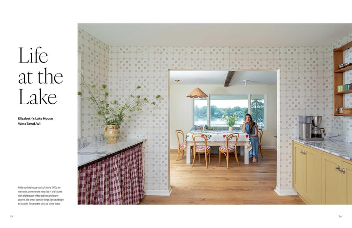 A magazine-style interior photo page with the headline 'Life at the Lake' and a photo of a woman standing in a bright kitchen and dining area. The page includes architectural text on the left and a large interior scene on the right showing patterned wallpaper, wood floors, counters, and a table with chairs.