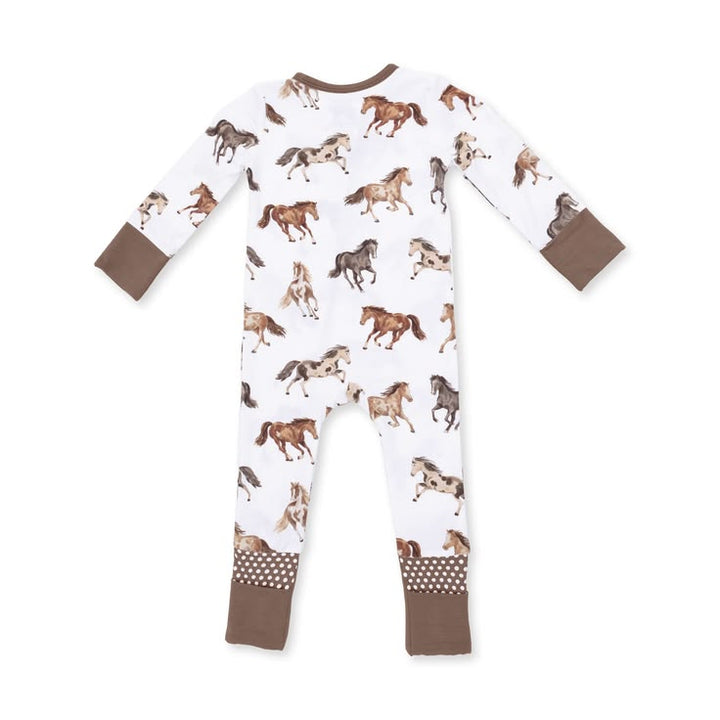 A baby long-sleeve footless one-piece pajama with an all-over horse print on a white background, featuring brown cuffs and leg cuffs with a polka dot pattern.