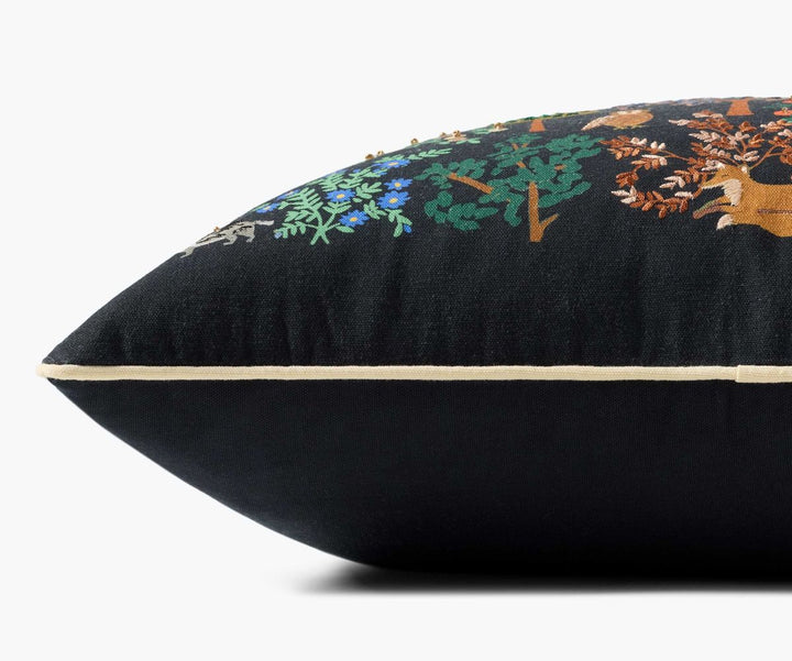 Black pillow with floral embroidery on a white background