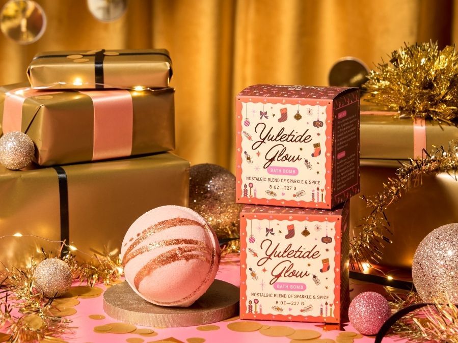 Yuletide Glow bath bombs with decorative packaging on a festive background